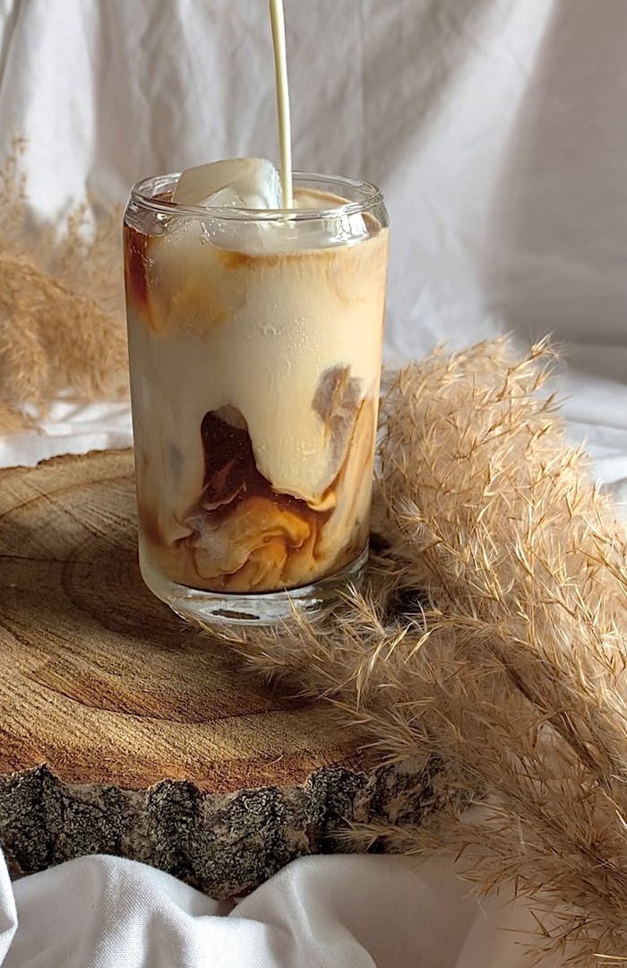 Pouring Milk on Ice Coffee